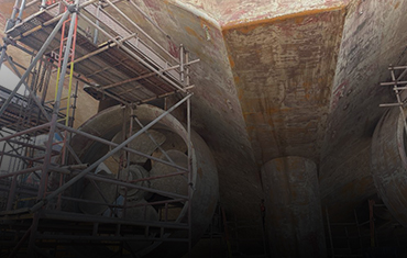 Metal structure with scaffolding in a scrap yard