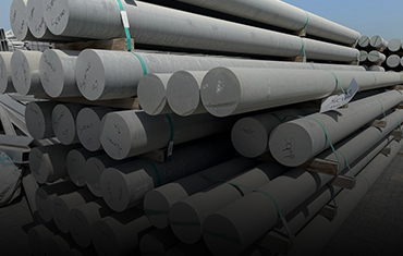 Stacked aluminium rods in a scrap yard